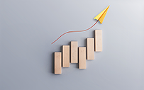 A set of blocks forming a bar chart with a yellow paper airplane.